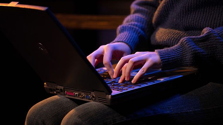 A student types on their laptop.