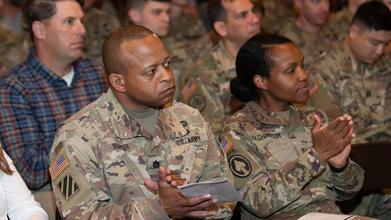 Student in military uniforms at commencement ceremony.