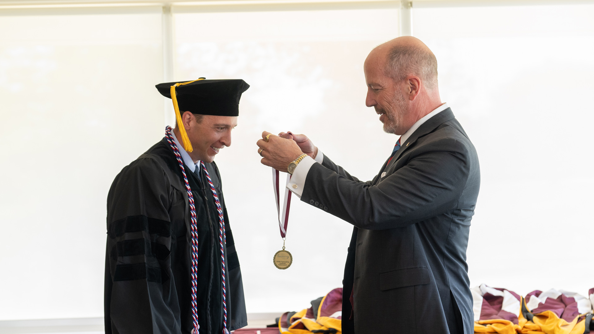 School director awards medal to graduate