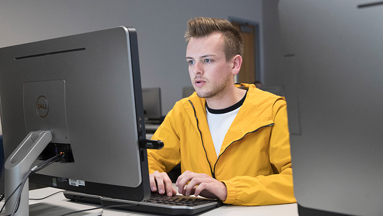 Student using laptop. 