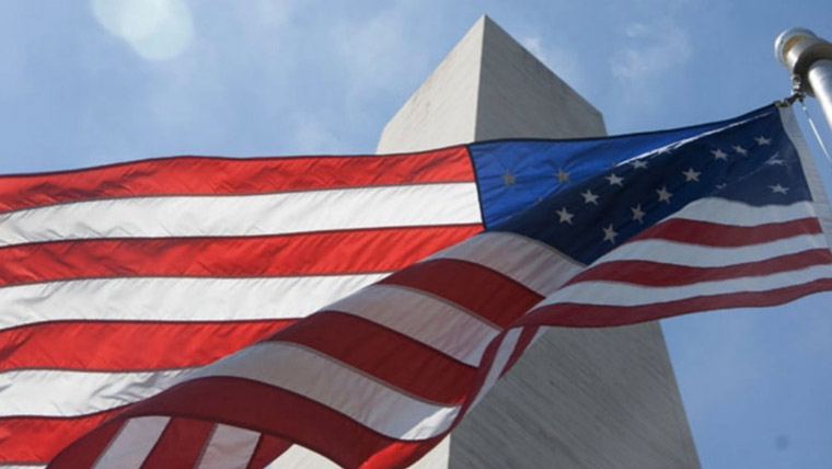 Flag waving in front of Washington Monument. 